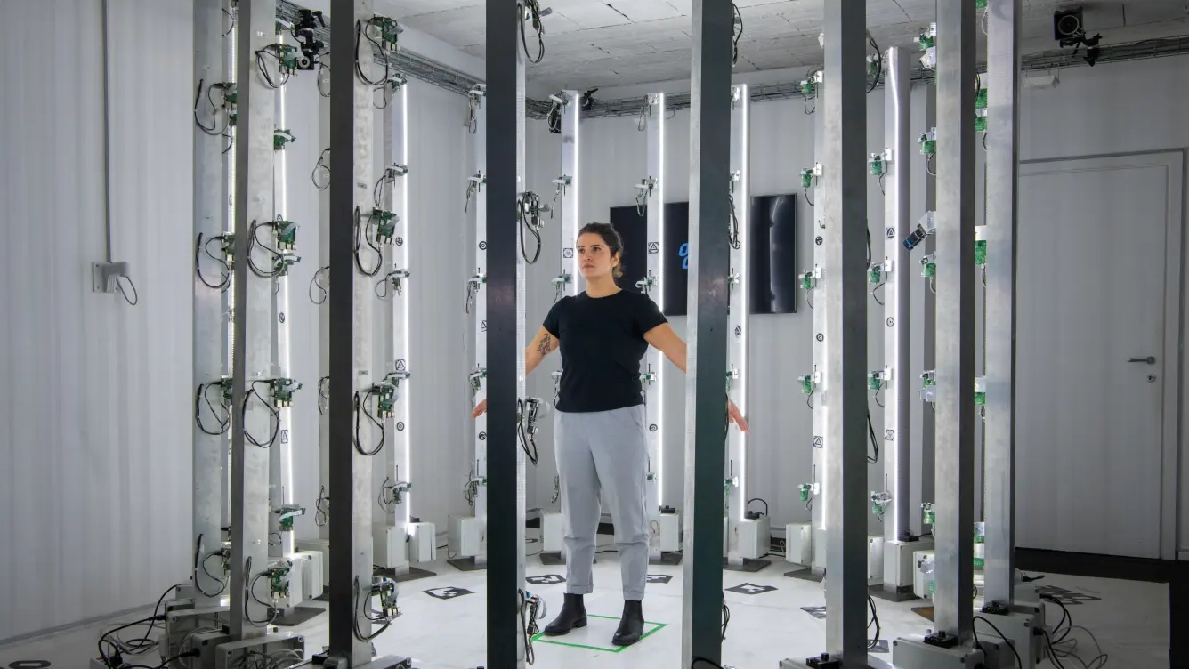 A team member in the 3D Scan cage 